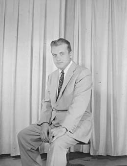 A second publicity portrait from the same curtain-backdrop session.