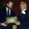 Ted Knight receiving a plaque at the testimonial dinner.