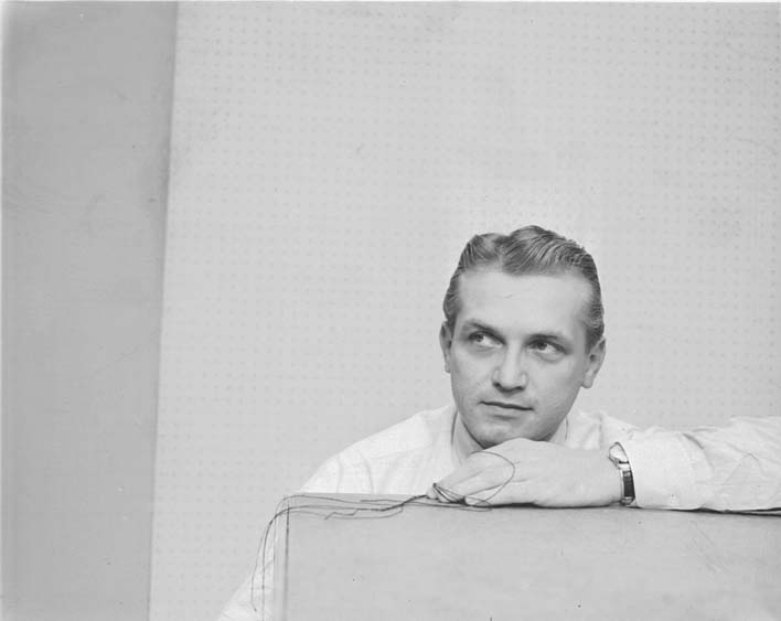 A second frame from the same session, Ted Knight leaning on the ledge with his wristwatch visible.