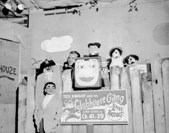 The Clubhouse Gang set with its cast of puppets ranged along the fence behind the show's sign.