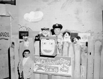 Ted Knight in uniform among the puppets on the Clubhouse Gang set.